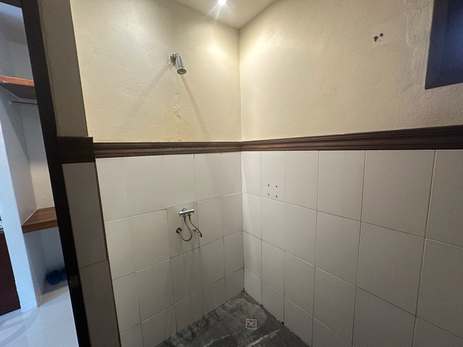 After: the same shower stall with the shadow lifted, the tile and the grout now visible.