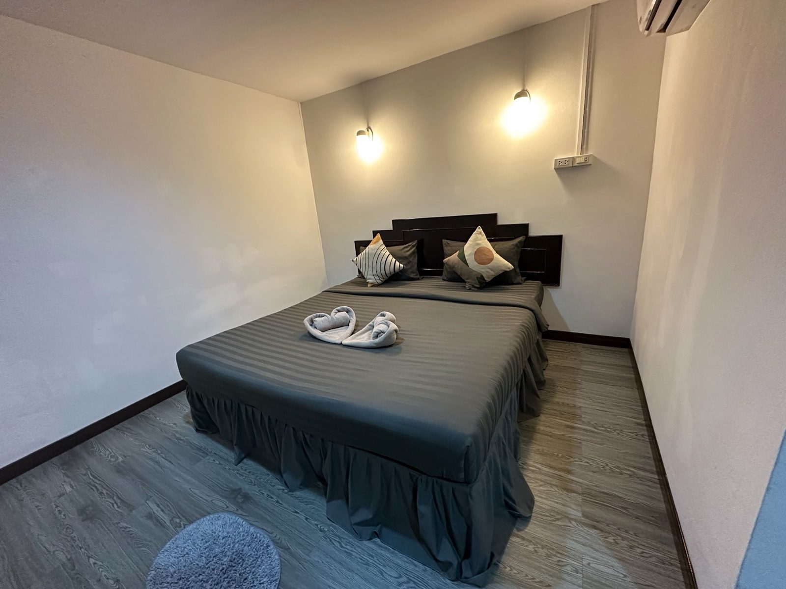 The same bedroom after processing. The shadow on the far wall has lifted and the wood-look floor has a little more contrast.